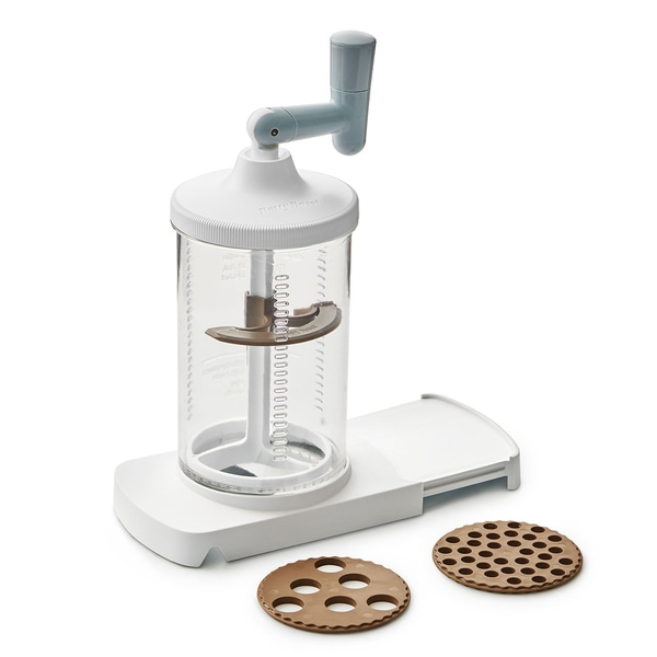 Machine à biscuits avec deux disques à biscuits, blanc et marron, sur fond blanc.