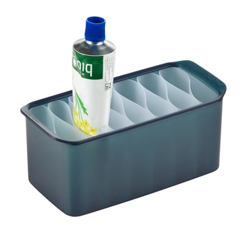 Behälter mit Tube. Blaue Tube in einem blauen Behälter mit Trennwänden.