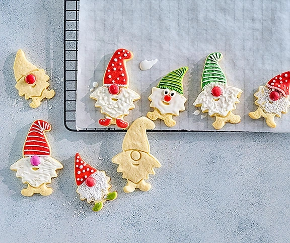 Weihnachtsplätzchen in Form von Zwergen mit roten Mützen und weißen Bärten.