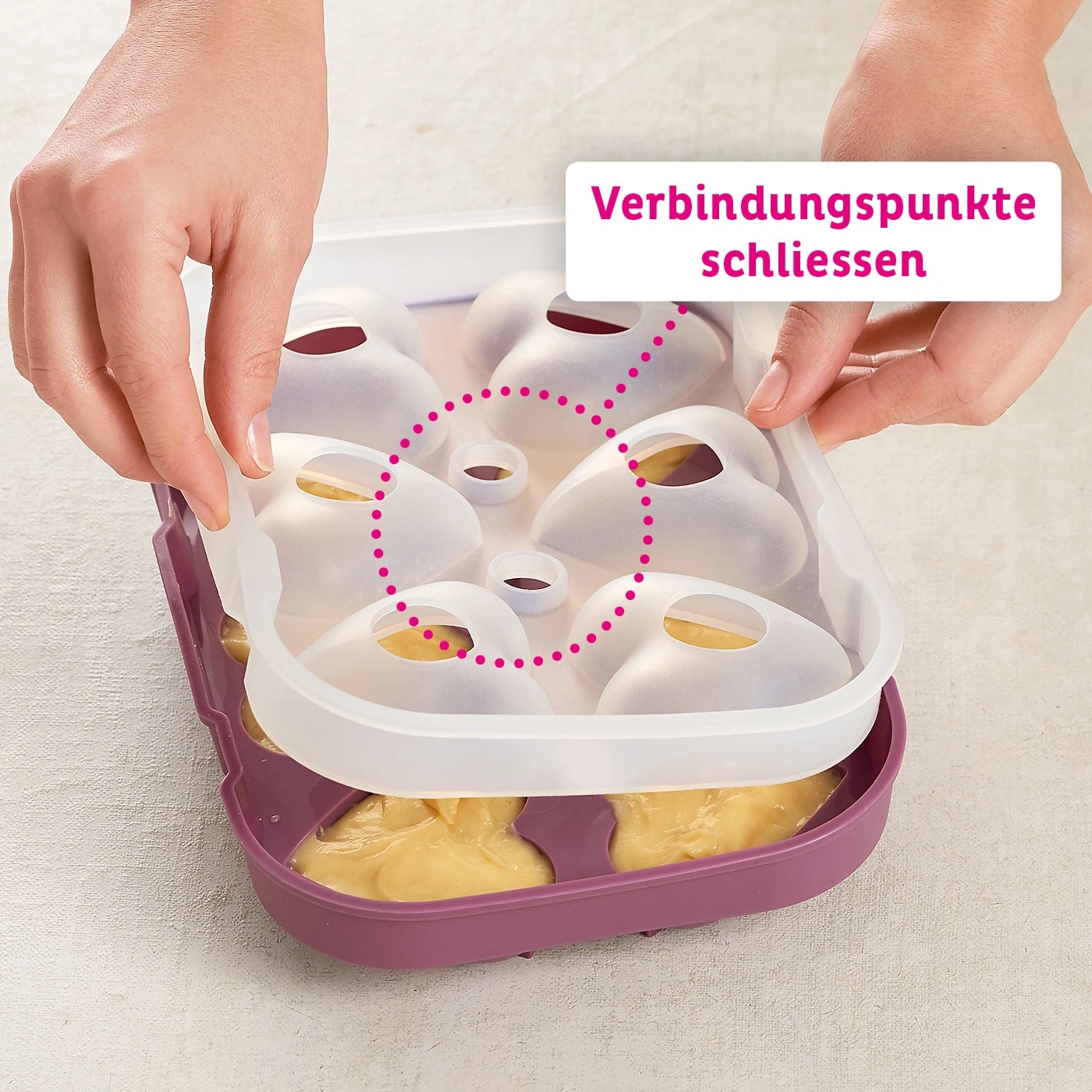 Mains fermant les points de connexion, récipient avec pâte, couvercle blanc, base violette.