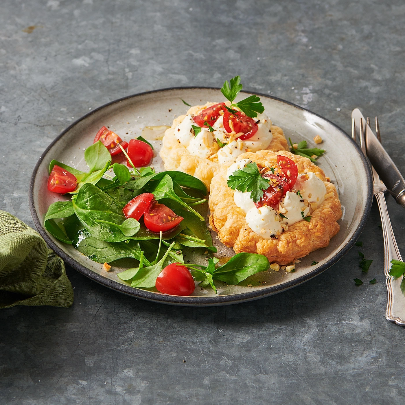 Köstliche Vorspeise mit Tomaten, Salat und Käse auf einem Teller serviert.