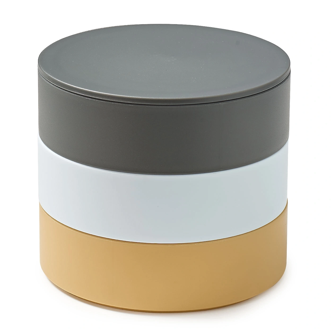 Récipient rond avec trois couches colorées : gris, blanc et beige.