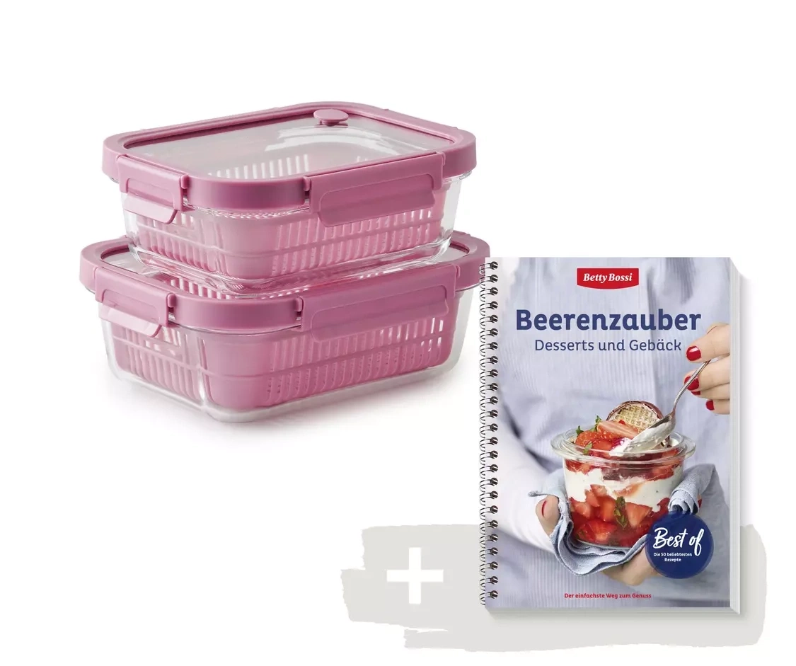 Deux récipients en verre avec des paniers et couvercles roses et un livre de cuisine intitulé "Beerenzauber".
