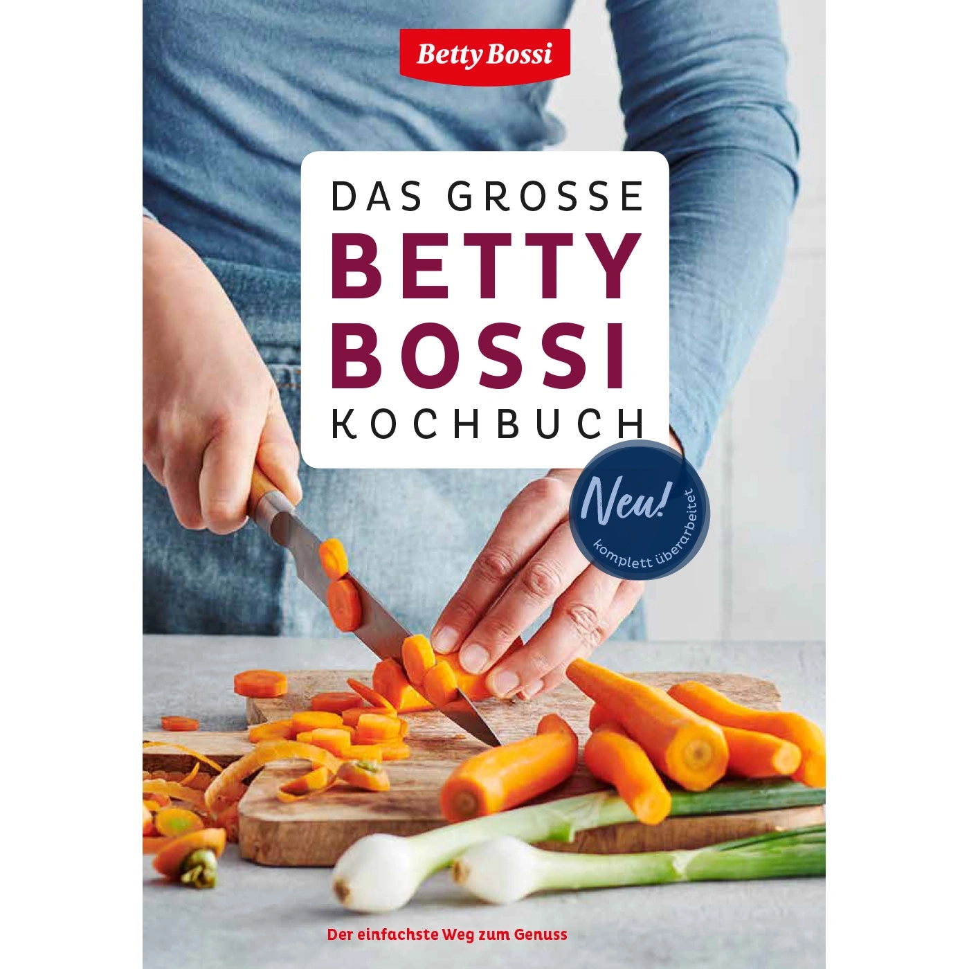 Kochbuch von Betty Bossi mit Karotten und Zwiebeln auf einem Schneidebrett