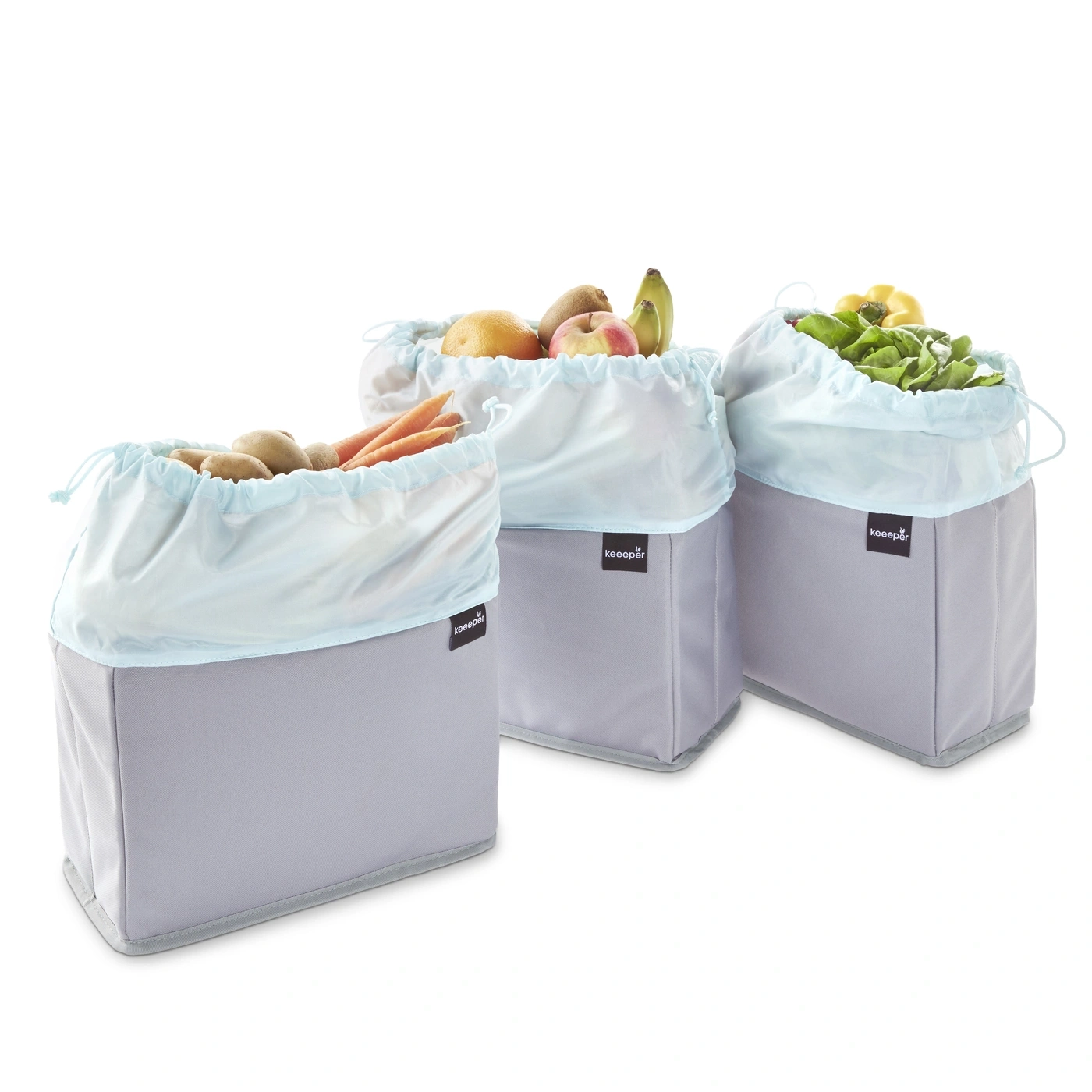Trois sacs de rangement remplis de fruits et légumes