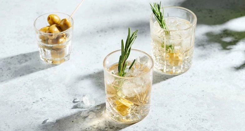 Cocktails mit Rosmarin und Oliven, erfrischend und lecker, auf einem Tisch